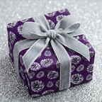 Elegant plum Christmas gift wrap with silver velvet ribbon and pinecone pattern.