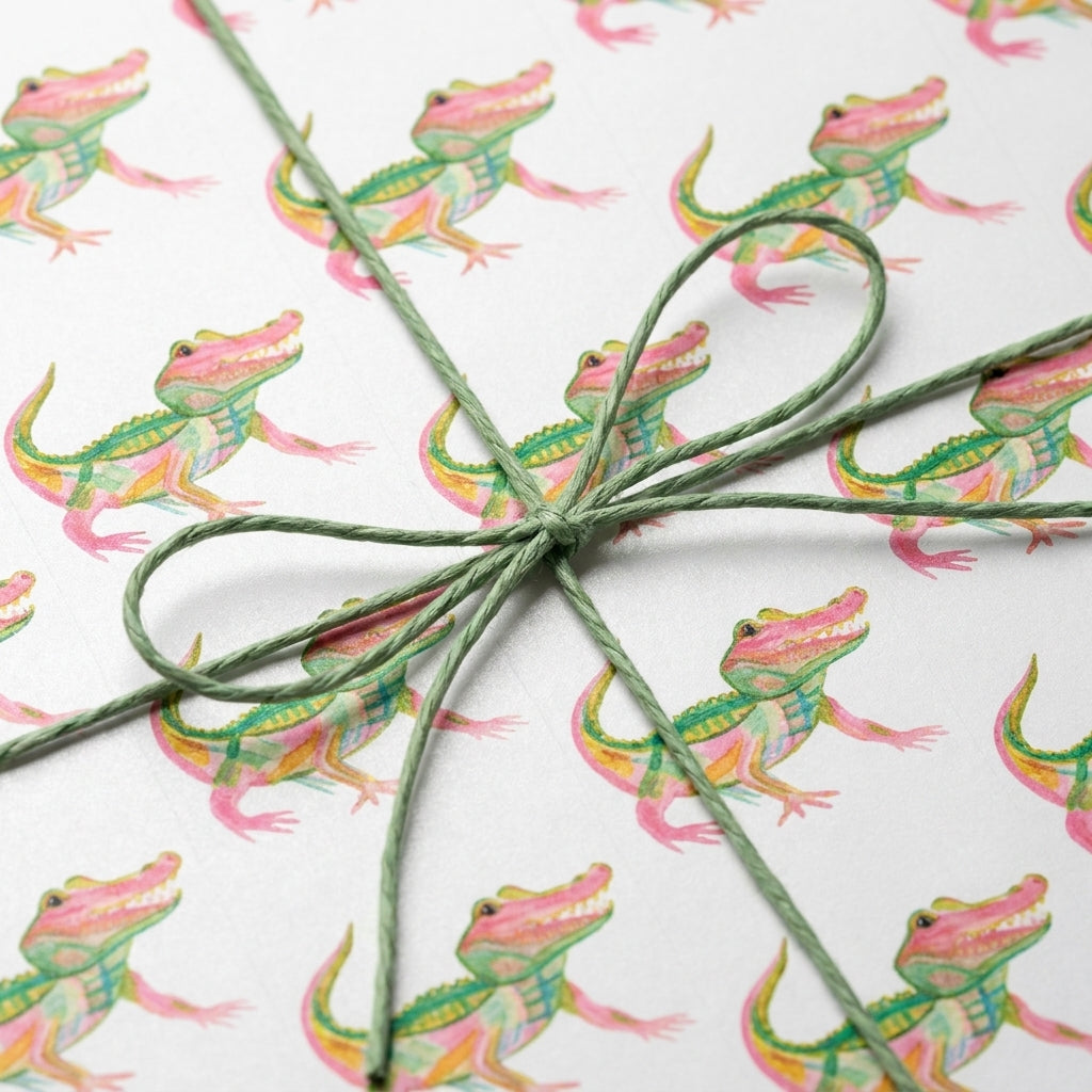 Cute alligator wrapping paper with a green twine bow, playful birthday gift wrap by Wrapped Studios.