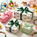 Cute alligator wrapping paper with green satin ribbons on kid's gifts by Wrapped Studios.
