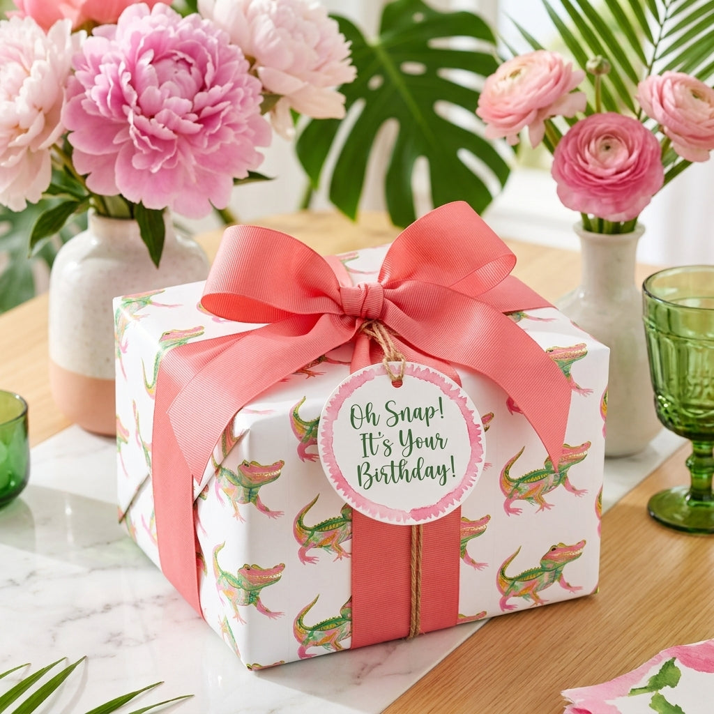 Cute alligator birthday wrapping paper with coral pink bow and gift tag, by Wrapped Studios.