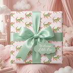 Alligator baby shower wrapping paper with a mint green bow and welcome tag, by Wrapped Studios.