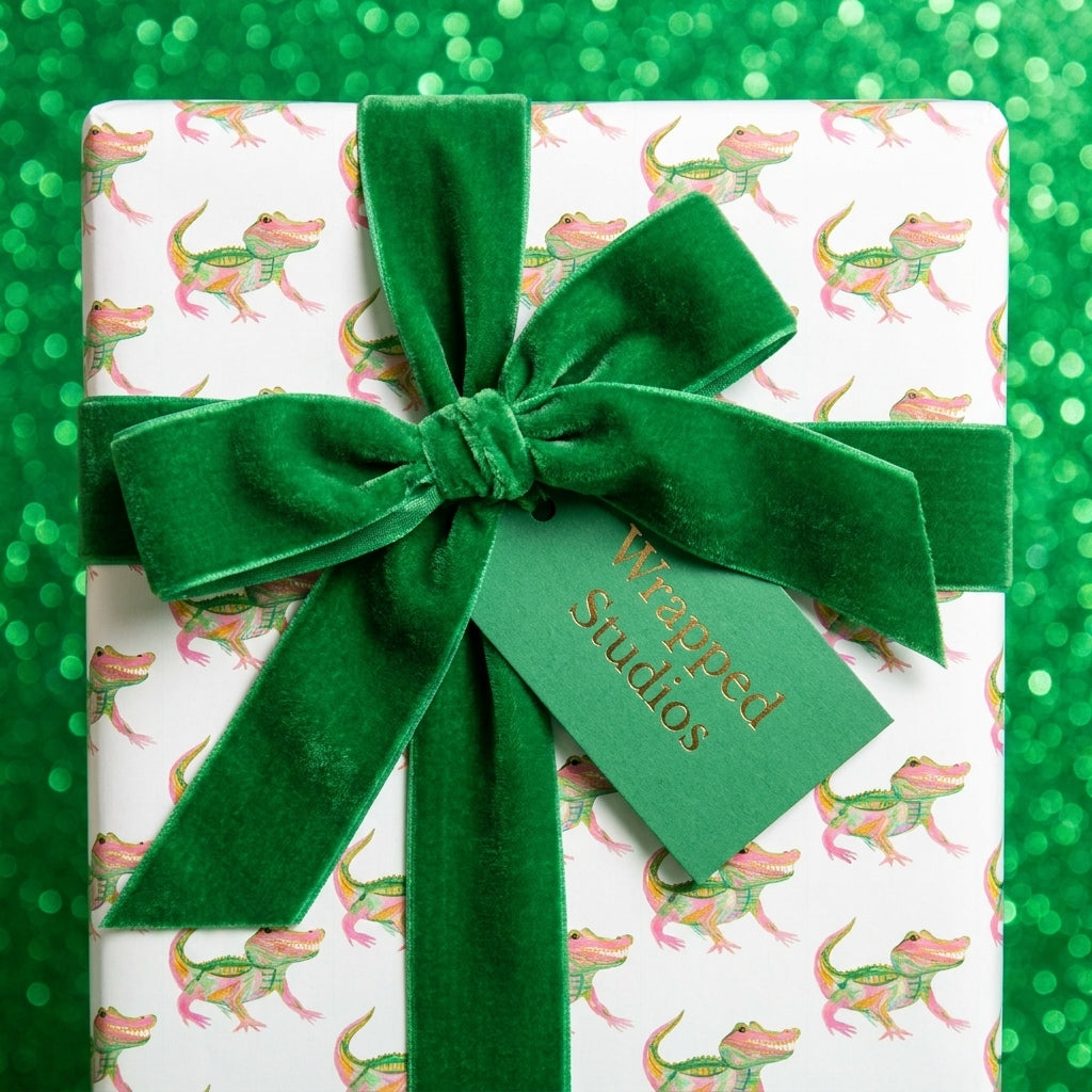 Whimsical alligator birthday wrapping paper with a green velvet bow by Wrapped Studios.