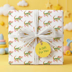 Cute alligator wrapping paper on a baby shower gift box with a white bow, by Wrapped Studios.