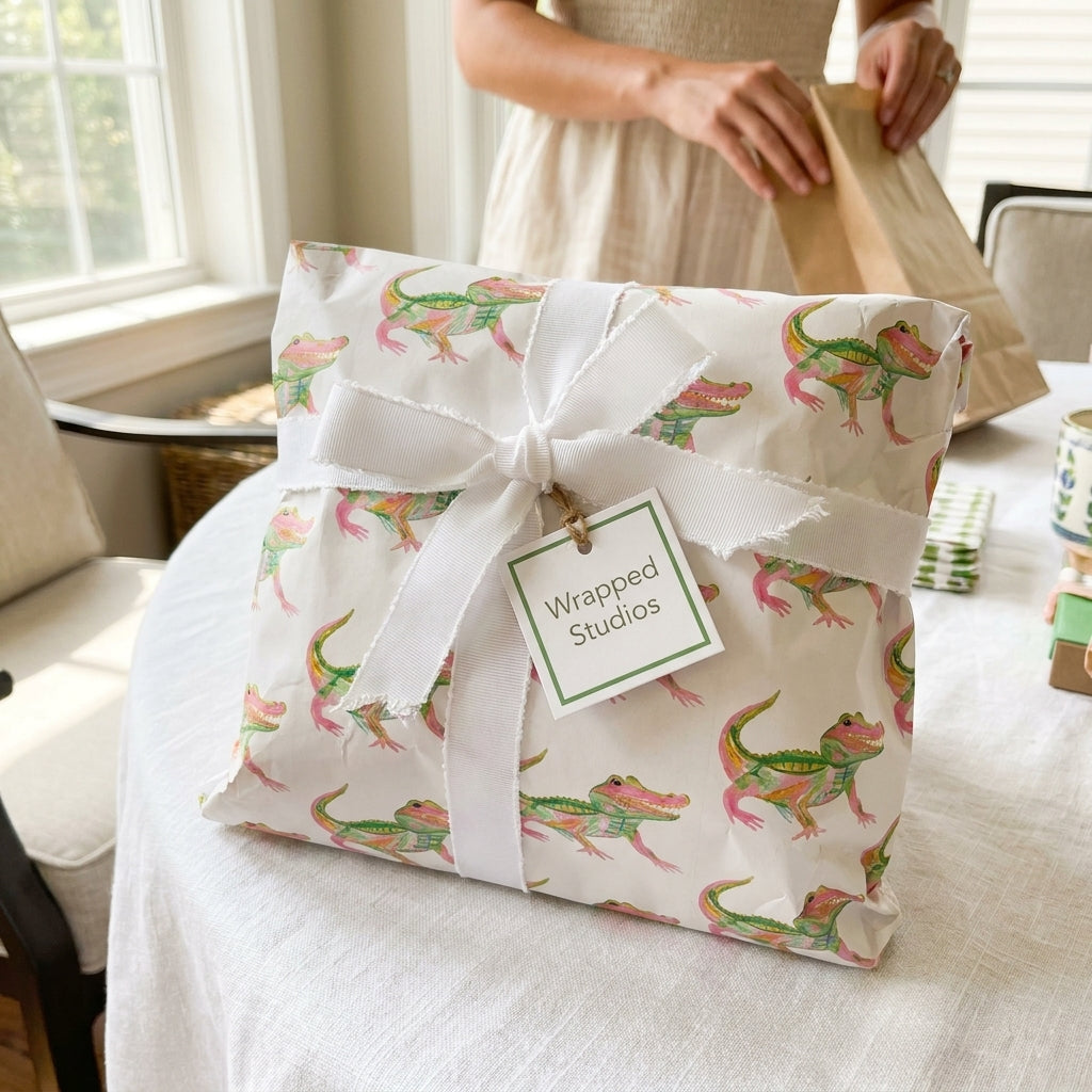 Cute alligator birthday wrapping paper with a white ribbon bow on a wrapped gift by Wrapped Studios.