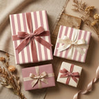 Pink striped luxury wrapping paper and gift boxes with velvet bows by Wrapped Studios.