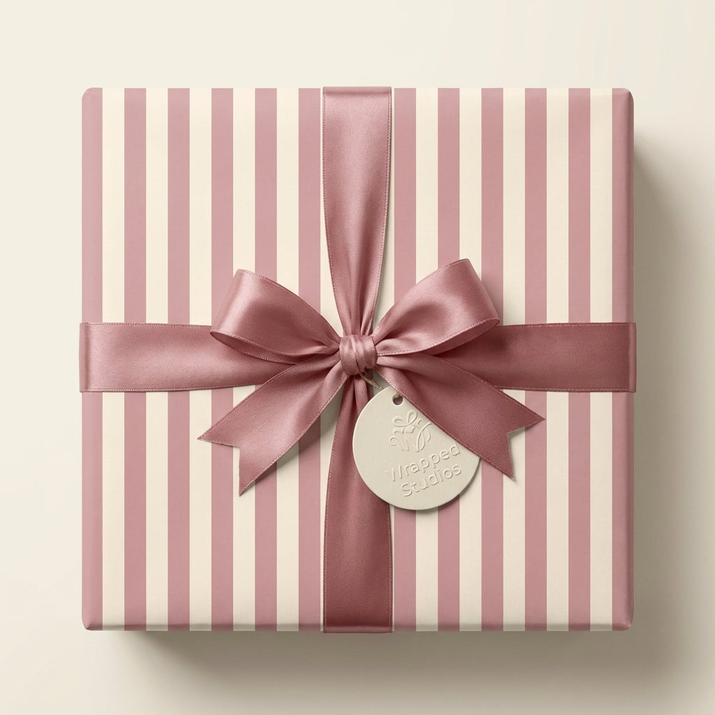 Elegant cream and pink striped birthday wrapping paper with a dusty rose satin bow, by Wrapped Studios.
