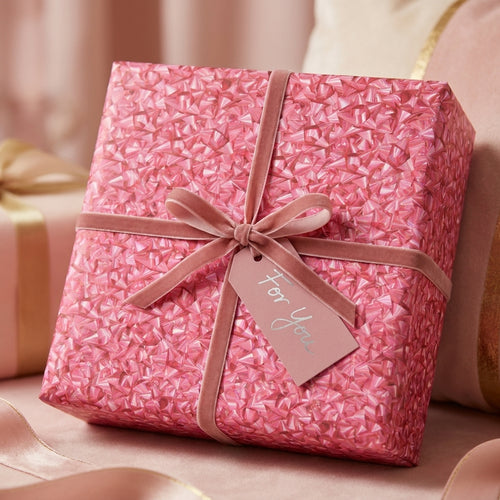 Luxury pink geometric wrapping paper with velvet ribbon for birthday gifts by Wrapped Studios.