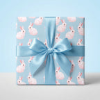 Pink bunny baby shower wrapping paper with a blue satin ribbon by Wrapped Studios.