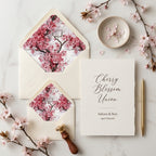 Cherry blossom wedding invitation and pink floral envelope liners by Wrapped Studios.