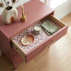 Pink floral wrapping paper used as a modern drawer liner in a mauve dresser by Wrapped Studios.