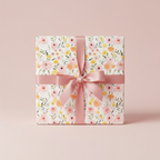 Gift wrapped in watercolor floral wrapping paper with a pink satin ribbon.