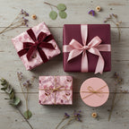 Elegant gifts wrapped in floral wrapping paper with velvet and satin ribbons on a rustic wooden surface.