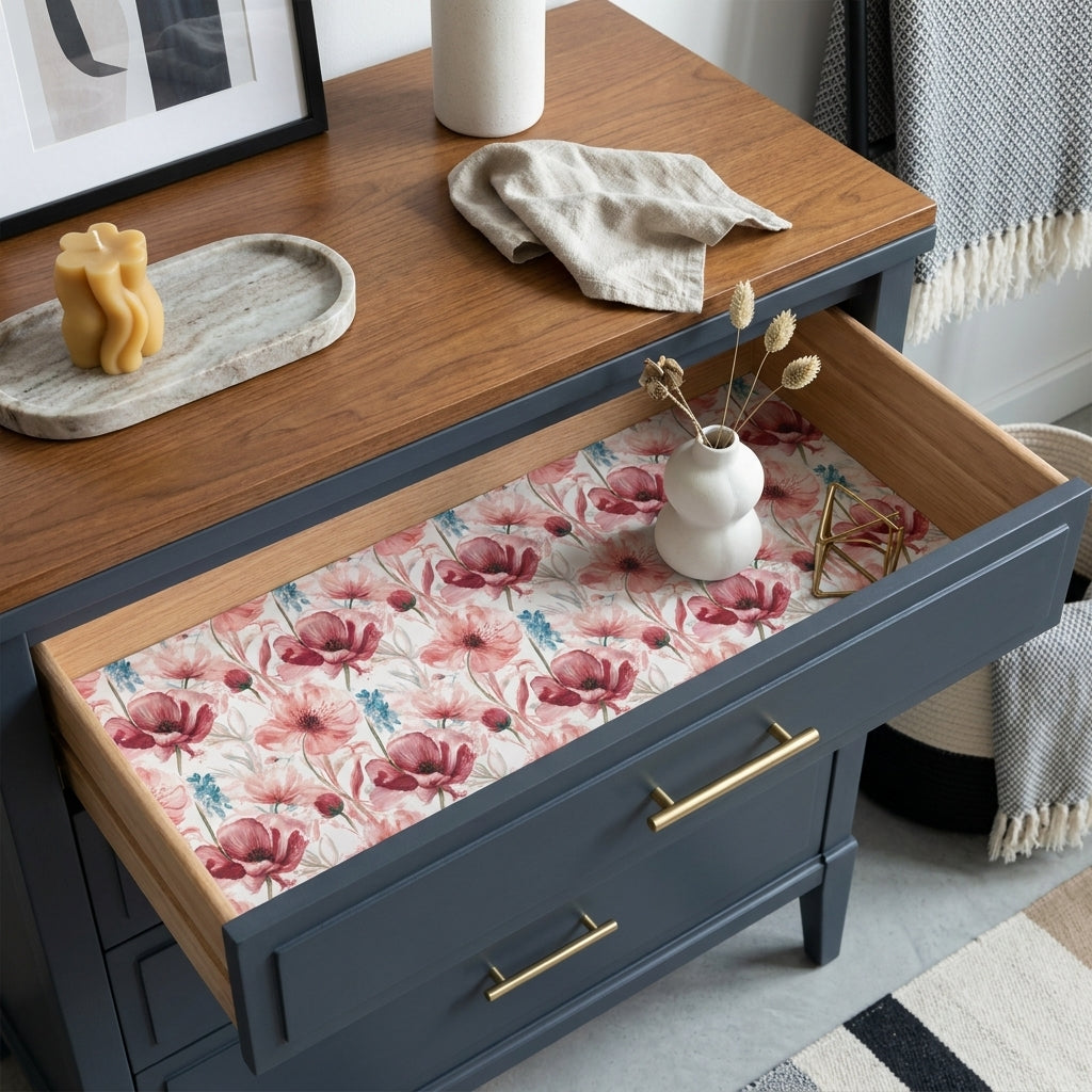Pink floral wrapping paper used as a drawer liner in a navy dresser by Wrapped Studios.