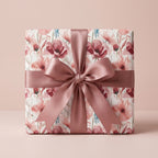 Elegant watercolor floral wrapping paper with a dusty rose satin bow by Wrapped Studios.