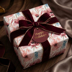 Luxury floral Christmas wrapping paper with a burgundy velvet holiday bow by Wrapped Studios.