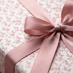 Vintage pink floral wrapping paper with a dusty rose satin bow by Wrapped Studios.