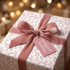 Elegant pink floral wrapping paper by Wrapped Studios, tied with a dusty rose velvet ribbon and gift tag.