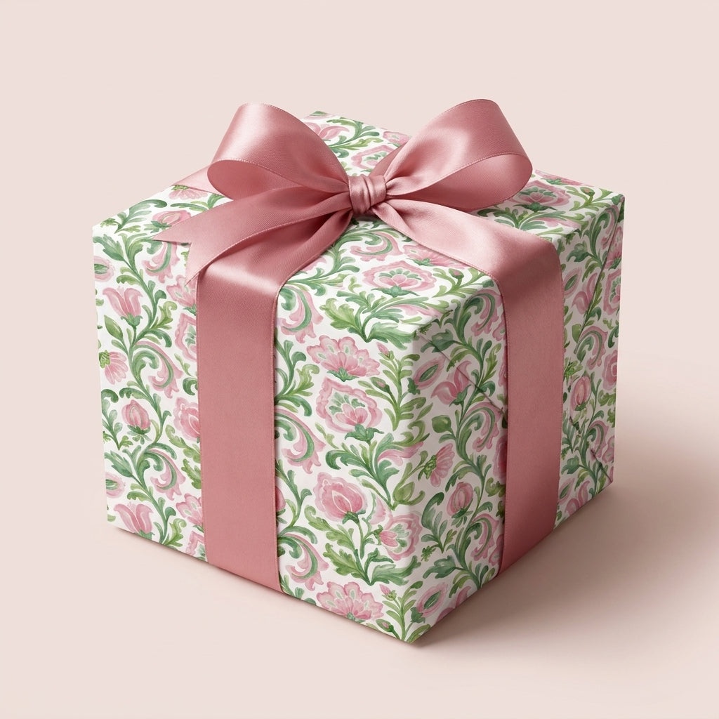 Vintage watercolor pink floral wrapping paper with a satin ribbon bow on a gift box by Wrapped Studios.