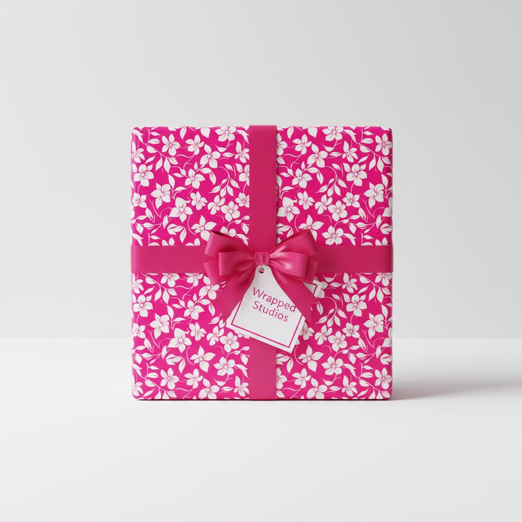 Square gift wrapped in pink floral wrapping paper with a pink ribbon and bow.