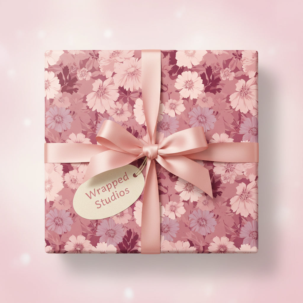 Square gift wrapped in pink floral wrapping paper with a satin ribbon bow.