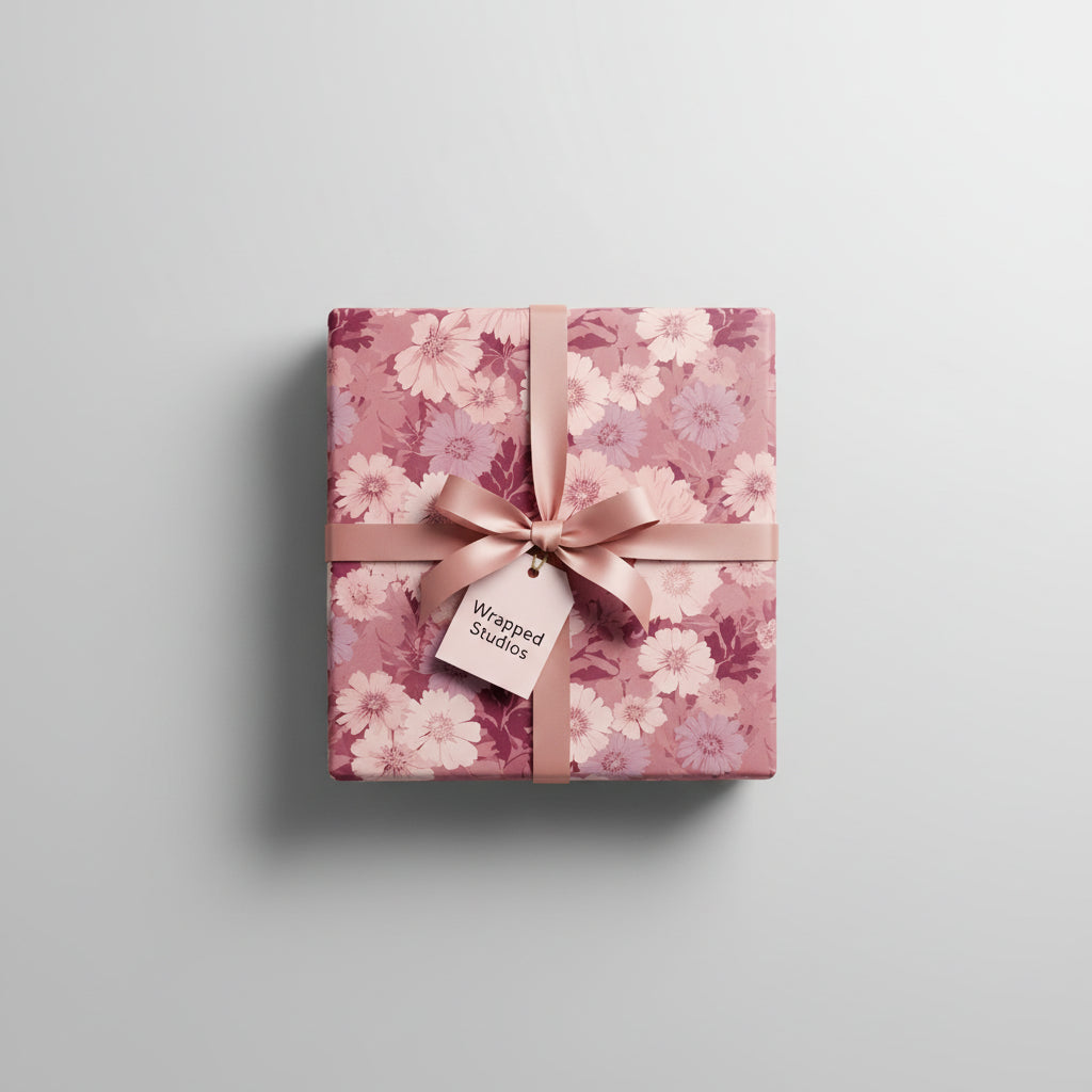 Square gift wrapped in blush floral wrapping paper with a matching satin bow.