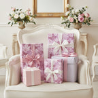 Elegant gifts wrapped in lilac floral wrapping paper with ribbons and bows for birthday or special occasion.