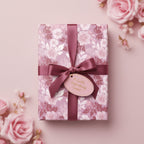 Elegant floral wrapping paper with mauve ribbon on a gift box, perfect for birthday or wedding presents.
