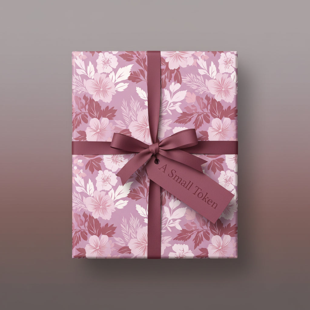 Elegant floral wrapping paper on a square gift box with a burgundy ribbon and "A Small Token" tag.