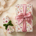 Elegant wildflower floral wrapping paper by Wrapped Studios on gifts with pink and green bows.
