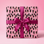 Pink graduation wrapping paper with graduate cap pattern and magenta bow by Wrapped Studios.