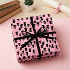 Pink graduation wrapping paper with black graduate caps and velvet ribbon by Wrapped Studios.