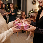 Passing Christmas gift wrapped in pink ornament paper, tied with a satin bow. Wrapped Studios.