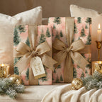 Luxury pink Christmas wrapping paper with green pine trees and gold bows by Wrapped Studios.