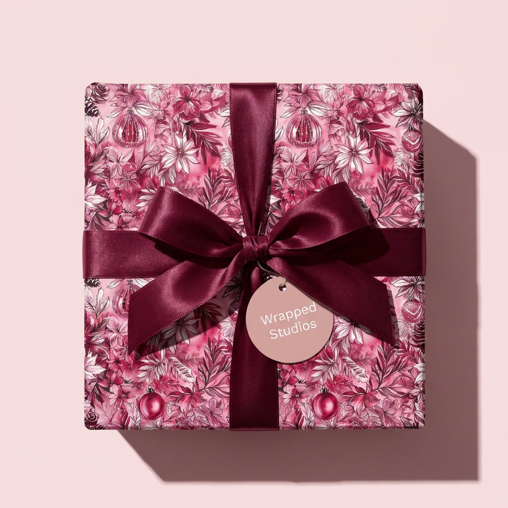 Wrapped Studios luxury Christmas gift wrap, floral design with burgundy ribbon.
