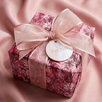 Wrapped Studios floral wrapping paper. Square gift wrapped with blush ribbon and tag.
