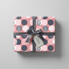 Gift wrapped in pink and gray polka dot wrapping paper with a gray ribbon and "A token of appreciation" tag.