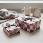Two gifts wrapped in pink polka dot paper with grey ribbon, elegant birthday wrapping paper.