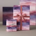 Elegant gifts wrapped in watercolor pink and purple paper with velvet ribbon and sparkly twine.
