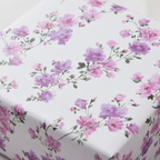 Elegant floral wrapping paper with delicate pink and purple blossoms, perfect for luxury birthday or wedding gifts.