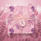 Elegant gift wrapped in pink floral wrapping paper with a sheer ribbon.