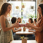 Woman gives gift wrapped in floral wrapping paper with twine bow at a gathering.