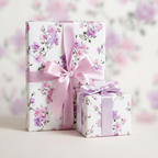 Elegant pink floral wrapping paper for gifts, featuring a satin ribbon and bow, ideal for birthdays or weddings.