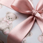Teddy bear wrapping paper with a dusty pink satin ribbon for a baby shower, by Wrapped Studios.