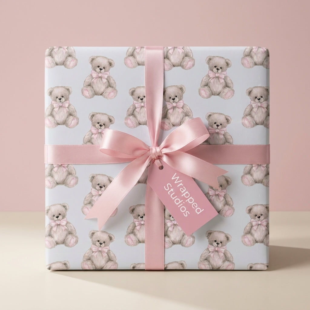 Cute teddy bear wrapping paper for baby shower gifts with a pink satin bow, by Wrapped Studios.