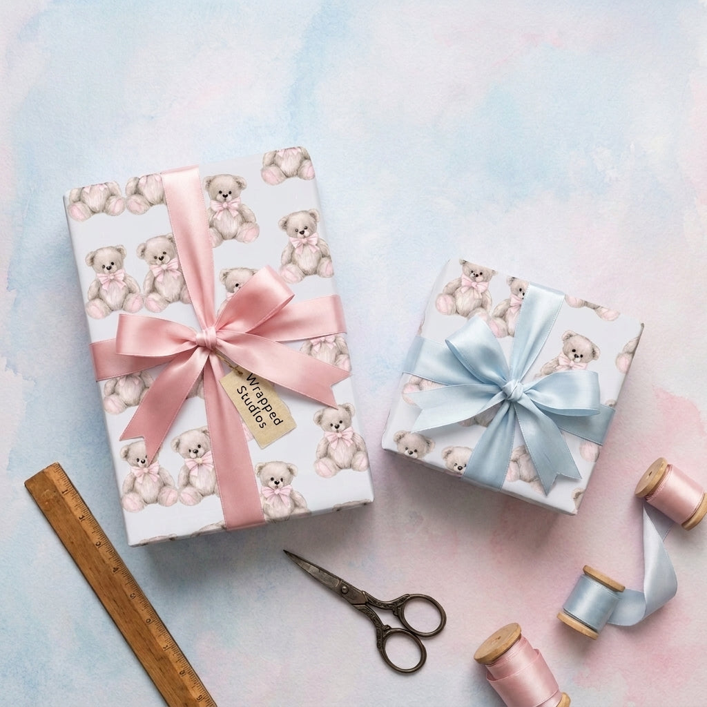 Cute teddy bear wrapping paper with pink and blue ribbons on baby shower gifts by Wrapped Studios.