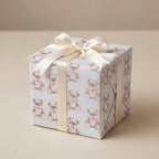 Teddy bear baby shower wrapping paper on a gift box with cream satin bow by Wrapped Studios.