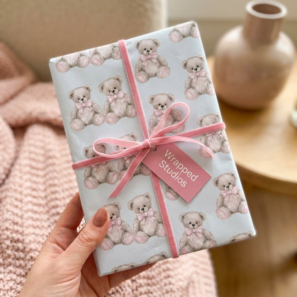 Teddy bear baby shower wrapping paper in pastel blue with a pink velvet ribbon by Wrapped Studios.