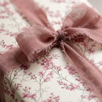 Vintage floral wrapping paper with a dusty rose ribbon bow, luxury gift wrap by Wrapped Studios.