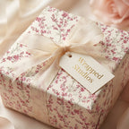Elegant pink floral wrapping paper by Wrapped Studios with a sheer cream bow, luxury wedding gift wrap.