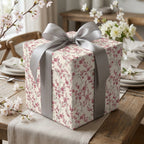 Elegant cherry blossom floral wrapping paper on a gift box with a silver satin bow by Wrapped Studios.